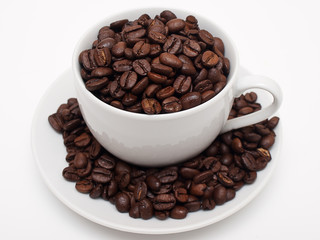 White cup filled with coffe beans