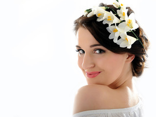 Beautiful fresh spring woman with flowers in her hair and pure s