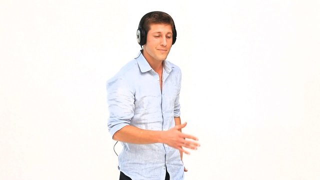 Casual man dancing with headphones
