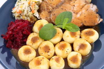 Pork steak and dumplings with side salads and sauce