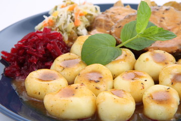 Pork steak and dumplings with side salads and sauce