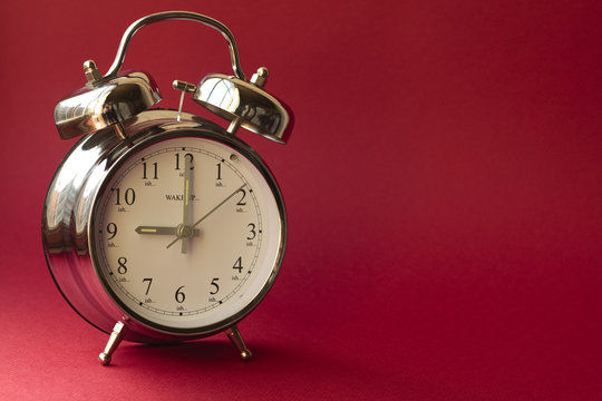 Alarm clock on red background