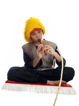 boy playing the flute charming a rope