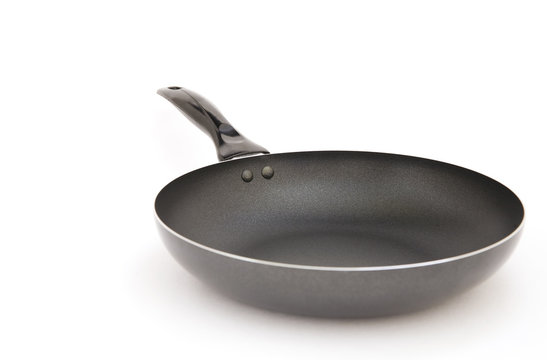 Black metal frying pan on a white background