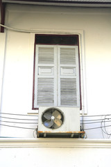 Old white window with air condition fan