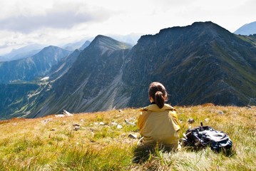 Naklejka na ściany i meble Young woman in mountains - relax scene