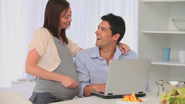 Future parents using a laptop