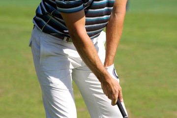 Detail of man playing golf