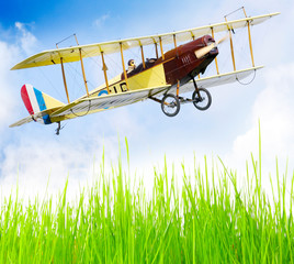 Flying biplane over a airfield. © Kletr