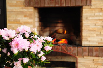 Fototapeta na wymiar flowers in front of a fireplace