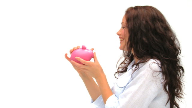 Woman putting her money in her piggy bank