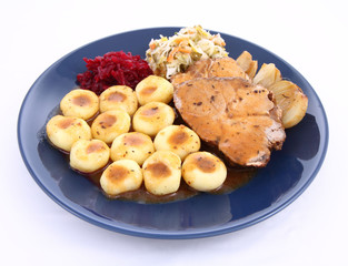 Pork steak and dumplings with salads and baked onions