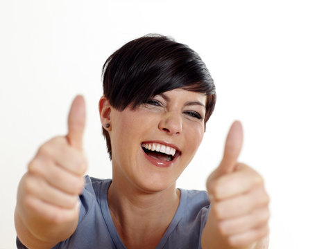 Portrait of attractive young female showing thumbs up