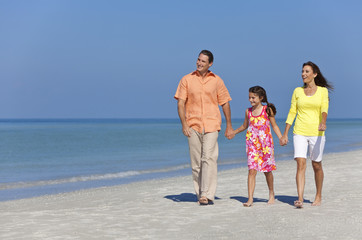 Happy Mother, Father and Daughter Family Walking on Beach
