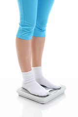 young athletic girl standing on the scales