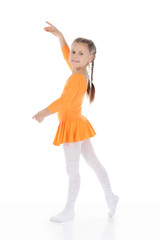 beautiful ballerina dancing in an orange dress.