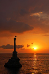 Sunset at Sevastopol harbor, monument to scuttled Russian ship