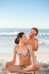 Fototapeta premium Attentive man applying sun cream on his girlfriend's back