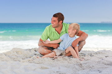Fototapeta premium Attentive father with his son at the beach