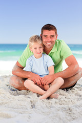 Fototapeta premium Attentive father with his son at the beach