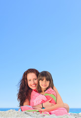 Fototapeta na wymiar Smiling woman with her daughter in a towel