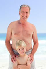 Grandfather with his grandson at the beach