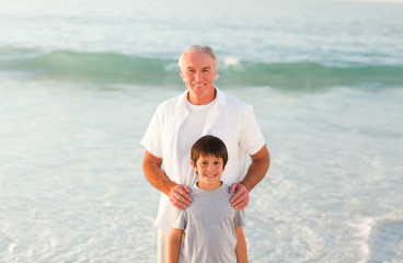 Grandfather and his grandson at the beach