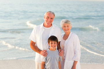 Grandparents with his grandson at the beach