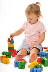 Baby in studiu is playing with blocks