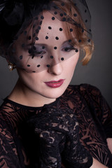Vogue style vintage portrait. Retro-stylized woman in black hat