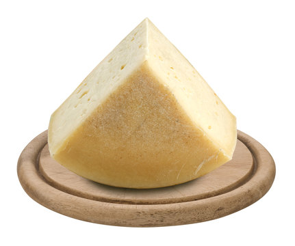 piece of italian cheese Montasio on wooden plate