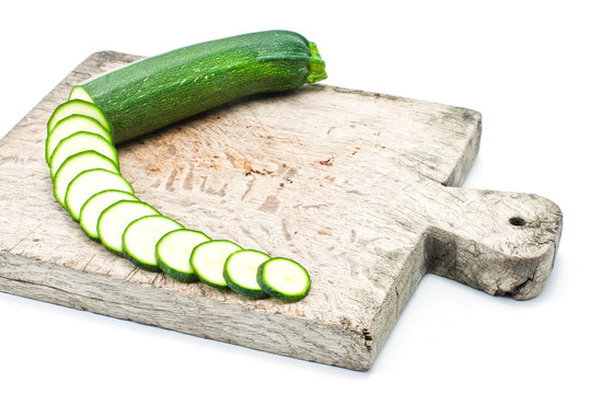 courgette cut to slices on breadboard