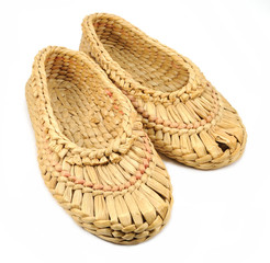 isolated old bast shoes with a hole