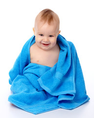 Cute child wrapped in blue towel