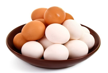 Group of brown and white hen's eggs in the plate isolated on whi