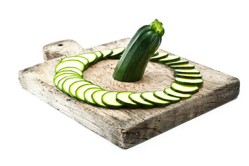 courgette cut to slices on breadboard