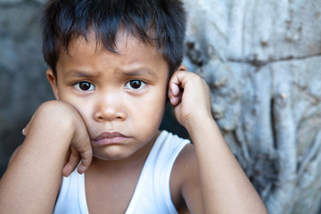 Asian boy against wall portrait