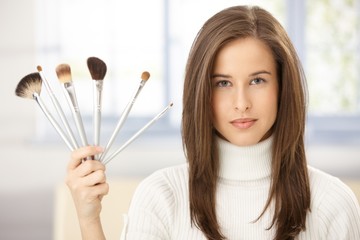 Woman with makeup brush collection