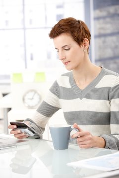 Office worker girl with smartphone