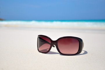 sunglasses in the sand at the beach