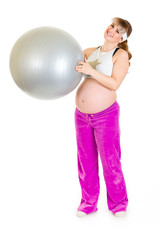 Fototapeta premium Smiling beautiful pregnant female in sportswear holding ball