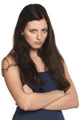 Naklejka premium Young offended female standing with crossed hands