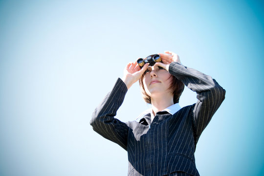 Young caucasian business lady with binoculars