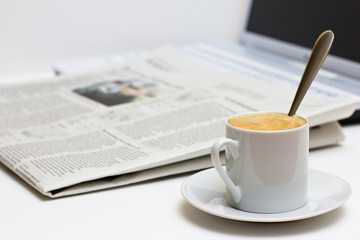 Cup of coffee and newspaper