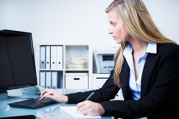 konzentrierte frau bei der arbeit am computer