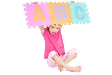 Girl holding up alphabet abc sign