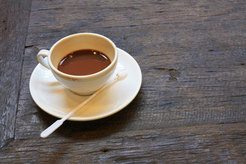 A cup of coffee on old wooden table