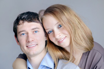Young man and woman with blue eyes are smiling