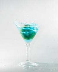 splashing on blue martini on white