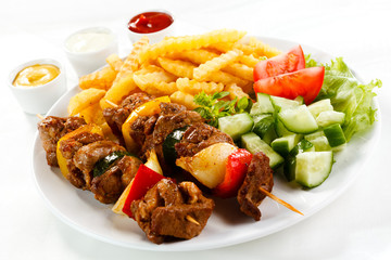 Grilled meat, French fries and vegetables